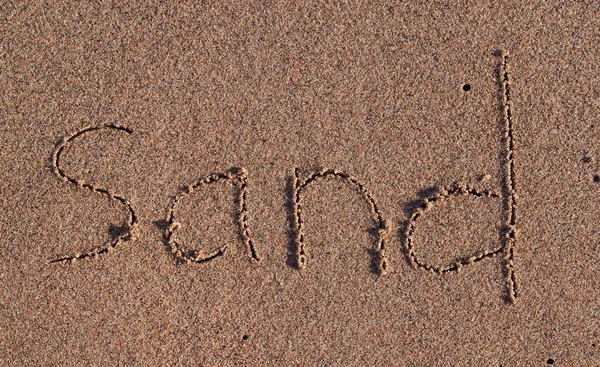 Iscrizione "sabbia" sulla sabbia — Foto Stock