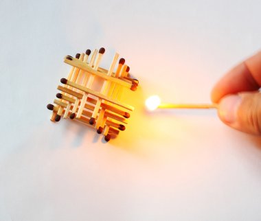 Building matchsticks and burning one in hand clipart