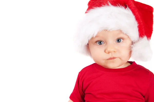 Adorable niño de Navidad en un sombrero rojo —  Fotos de Stock