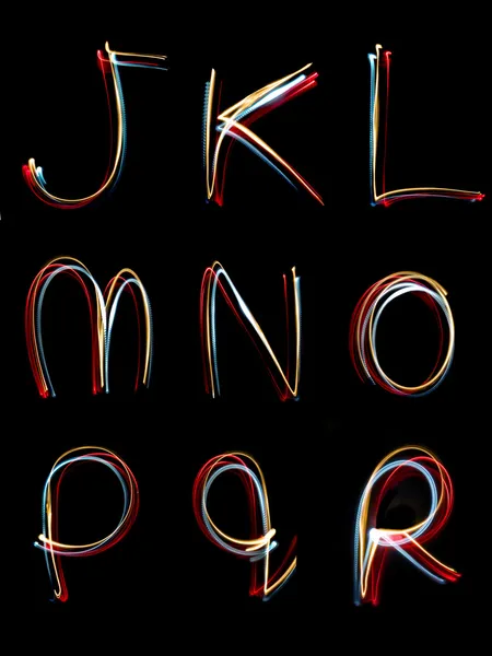 Lichte neon alfabet schrijven lange blootstelling — Stockfoto