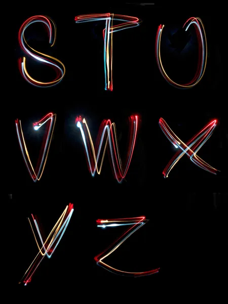 Alfabetet ljus neon skriva lång exponering — Stockfoto