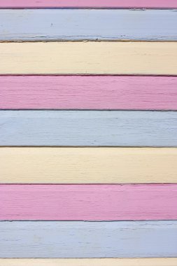 Striped colourful painted wood in pink, yellow and blue clipart