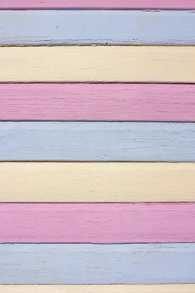 Striped colourful painted wood in pink, yellow and blue — Stock Photo, Image