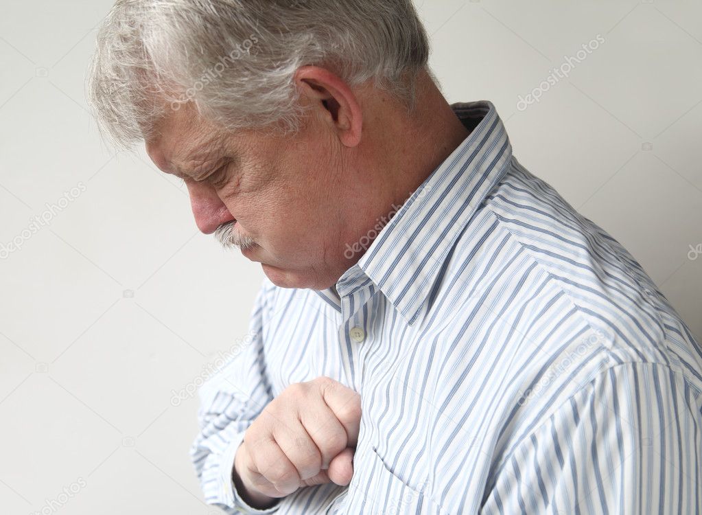Senior man suffers from bad heartburn