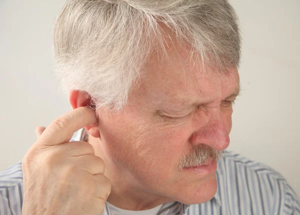 Ear pain in a senior — Stock Photo, Image