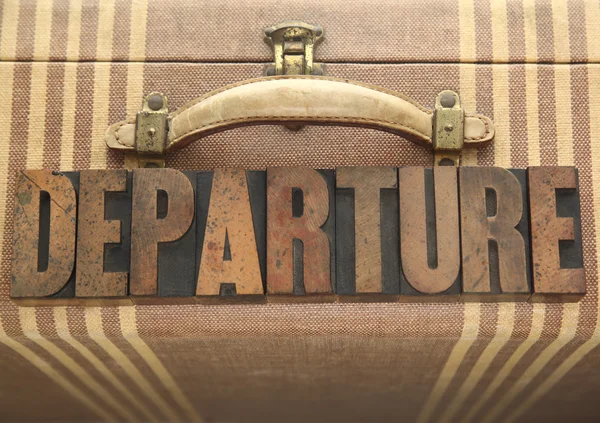 Departure word on old luggage — Stock Photo, Image