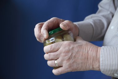 Senior man tries to open jar clipart