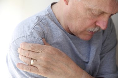 Shoulder pain in a senior man clipart