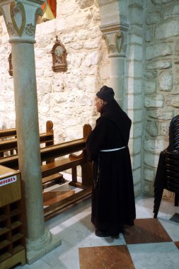 Franciscan monk in the Church of Jesus' first miracle, Cana, Israel clipart