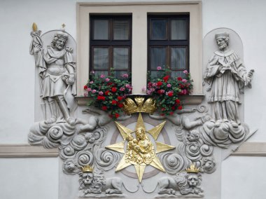 Prague, House of the Golden Well, Madonna and Child surrounded by saints clipart