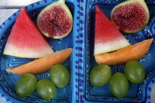 stock image Grapes, figs, watermelon and melon in a blue bowl