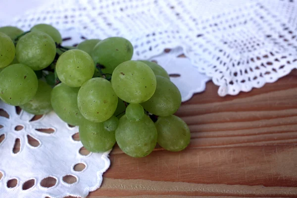 Grape cluster on a white tablecloth — Stock Photo, Image