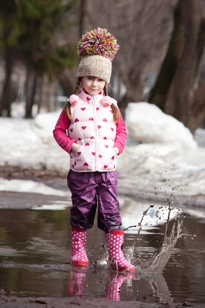Girl playing in puddles — Stock Photo, Image