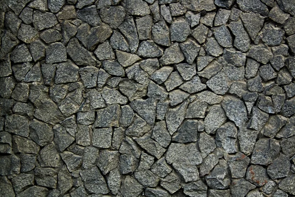 Grungy vittrad sten spillror mosaic väggyta. — Stockfoto