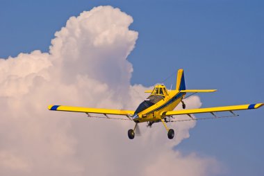 Crop Duster Out Of The Clouds clipart