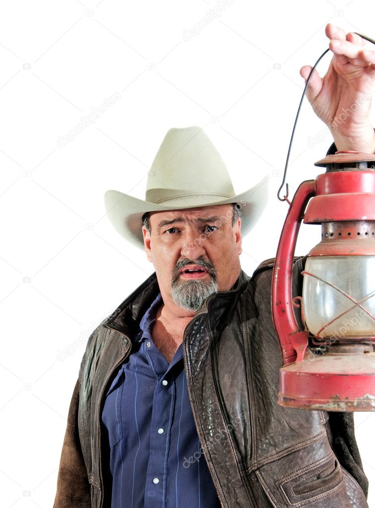 Adult male cowboy holding lantern