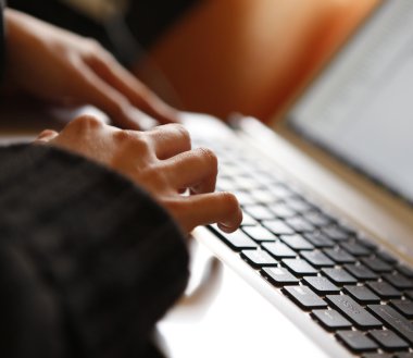 Young woman working on laptop clipart