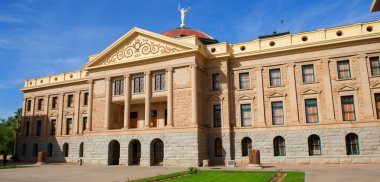 Arizona State Capital with windows, pillars, bright blue sky and green grass clipart