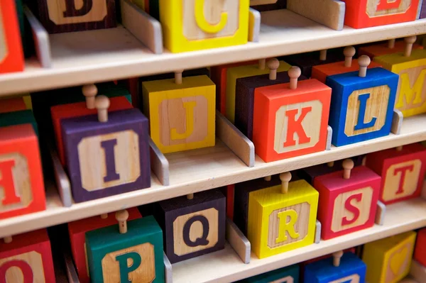 Rows of Children's Alphabet Blocks on Shelves — Stock Photo, Image