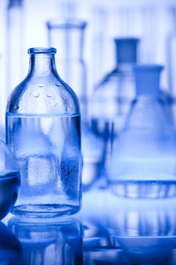 Glass laboratory equipment with blue background