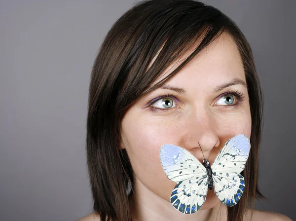 Бабочка на губах — стоковое фото