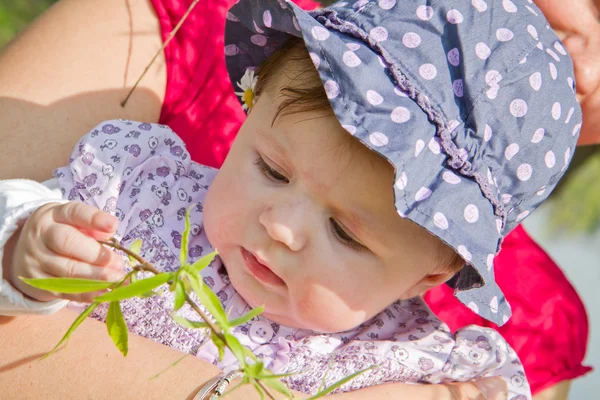 Bébé jouant avec la lame d'herbe — Photo