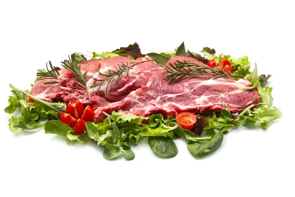 Sliced raw meat with salad — Stock Photo, Image