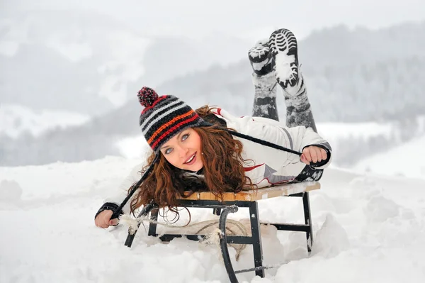 stock image Young Beautiful Woman on sledge in winter time