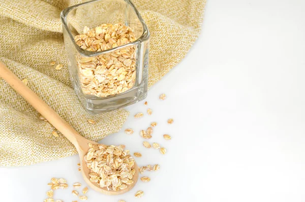 Oat-flakes with a wooden spoon — Stock Photo, Image