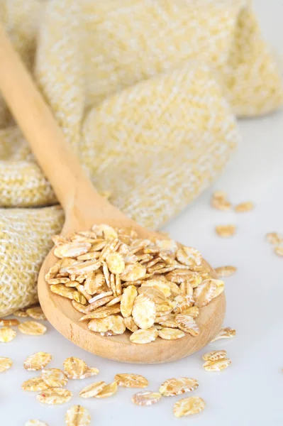Oat-flakes with a wooden spoon — Stock Photo, Image