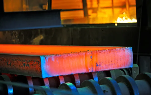 Hot steel on conveyor — Stock Photo, Image
