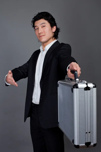 Asian man and metall case — Stock Photo, Image