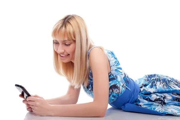 Woman lie with mobile phone on a white — Stock Photo, Image