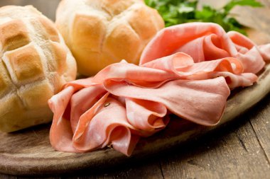 Mortadella with Bread on Chopping board clipart