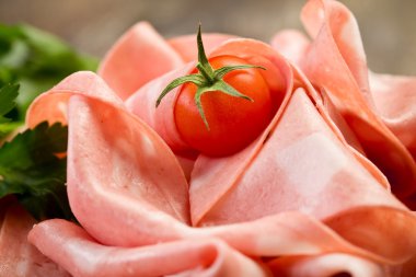 Mortadella slices with red pepper clipart