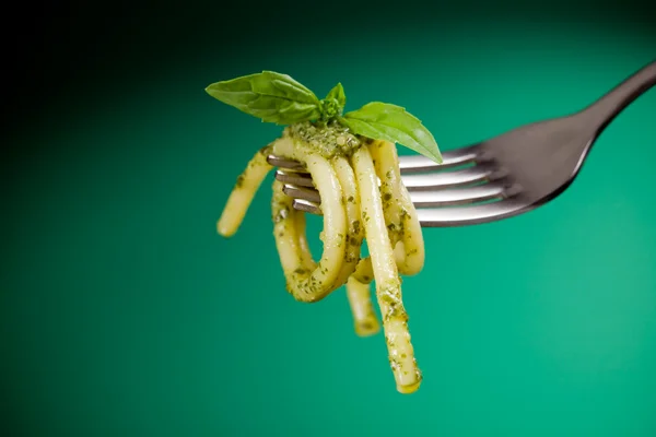 Pasta with pesto wrapped on a fork — Stock Photo, Image