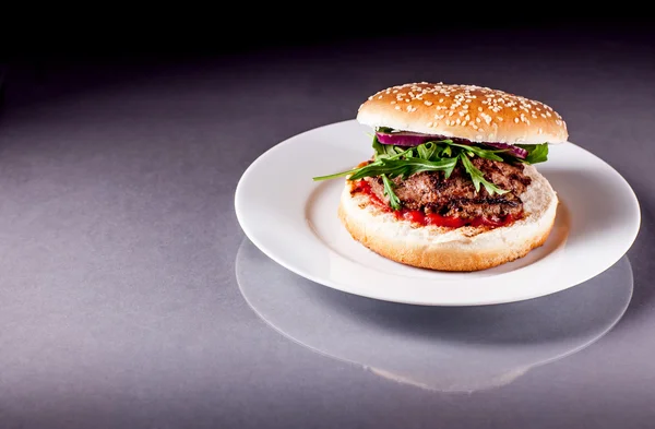 Hamburger met rucola op grijze oppervlak — Stockfoto