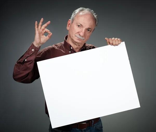 Old man holding empty bill board — Stock Photo, Image