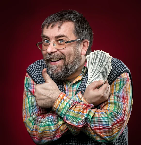 Old businessman showing fan of money — Stock Photo, Image