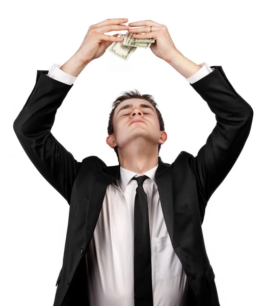 Young businessman holding dollar bills over his head — Stock Photo, Image