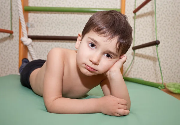 Criança está em um colchão esportivo — Fotografia de Stock