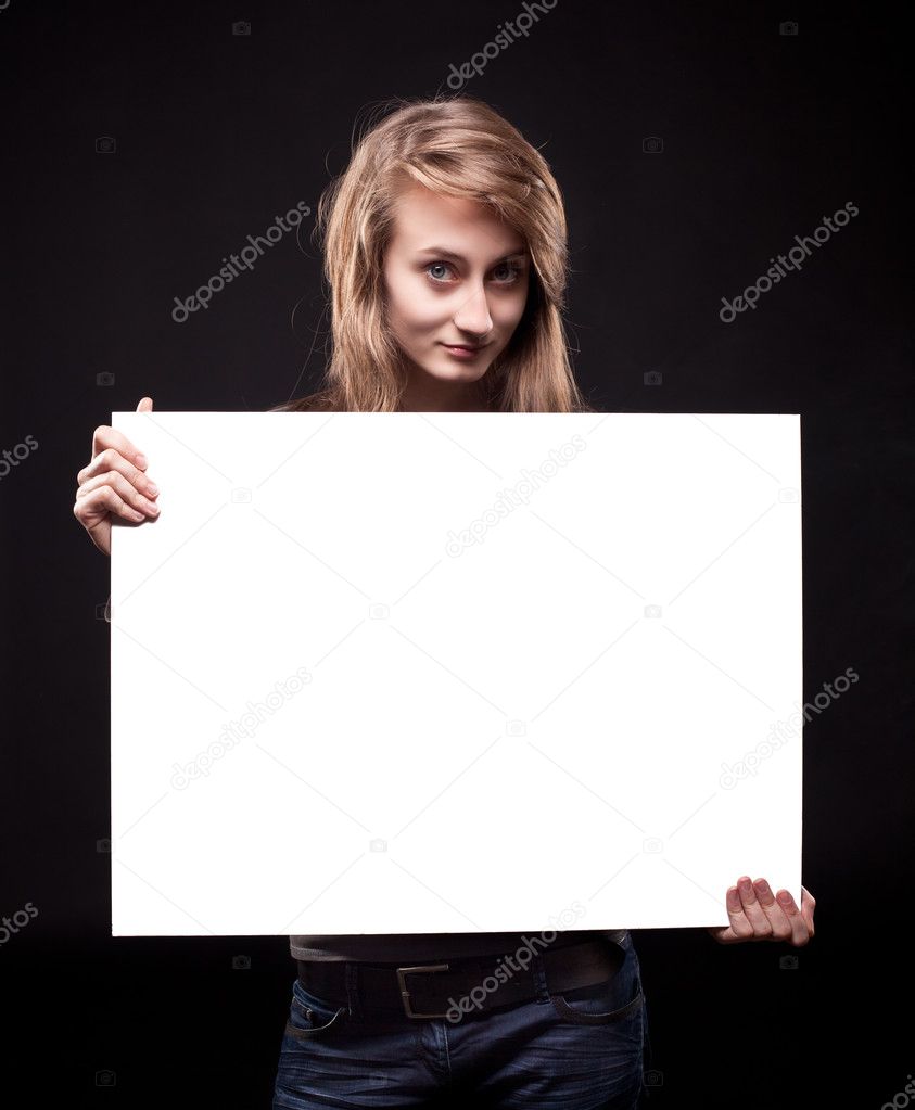 Young woman holding empty billboard