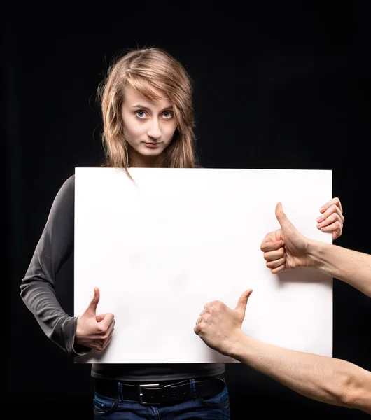 Young woman holding empty billboard — Stock Photo, Image