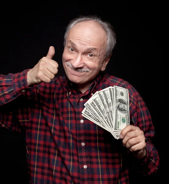Elderly man showing fan of money — Stock Photo, Image