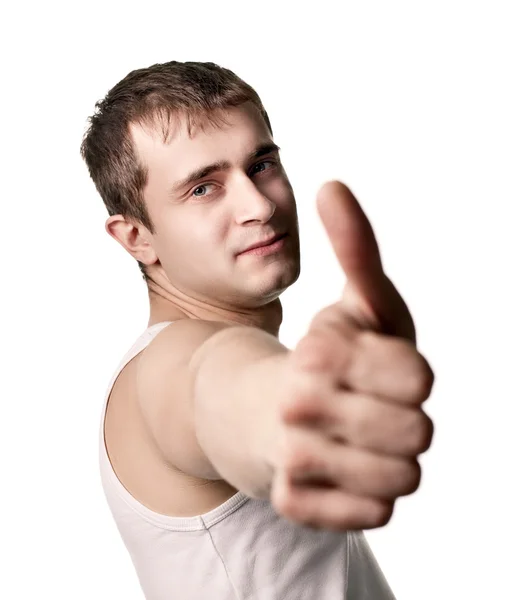 Mladý muž ukazující palec nahoru — Stock fotografie