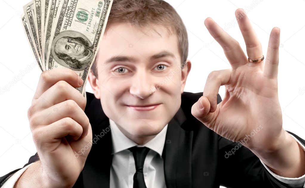 Businessman showing fan of money and sign OK