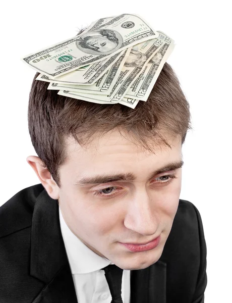Upset businessman with money on head — Stock Photo, Image