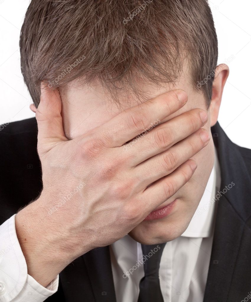 Man covering his face by hand