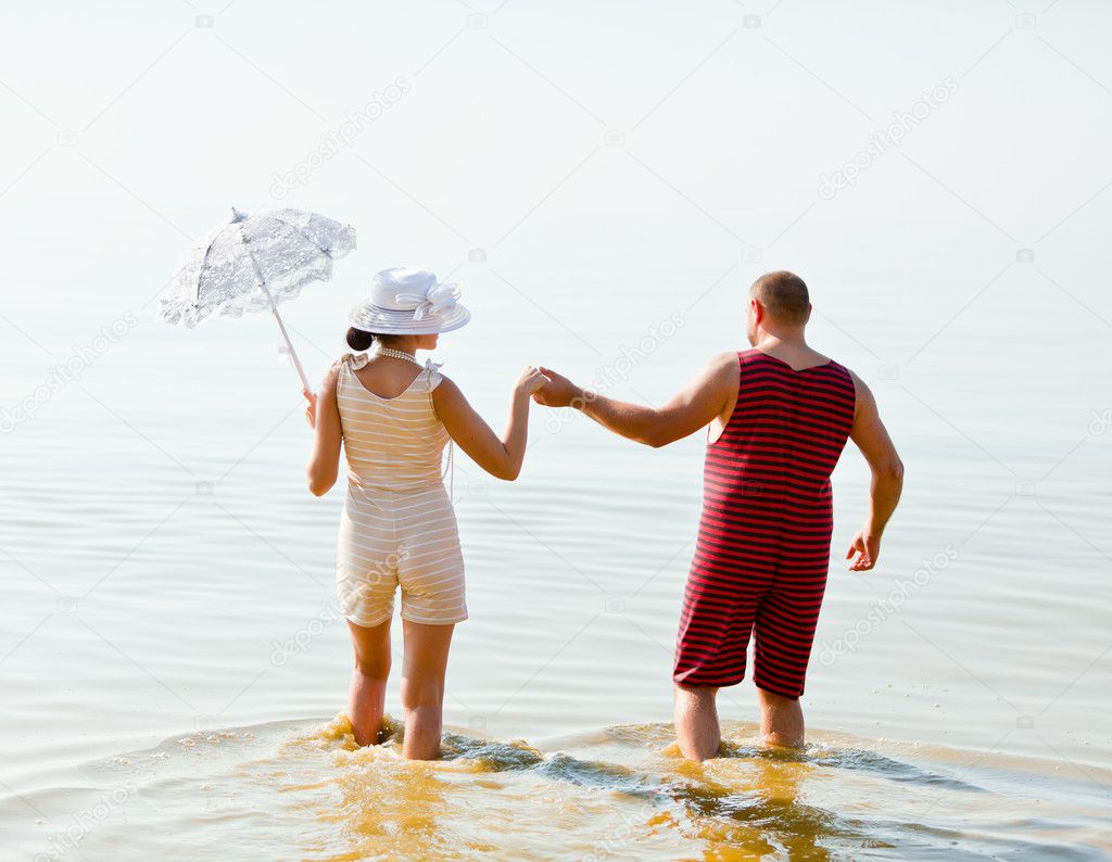 Man and a woman in vintage striped bathing suits