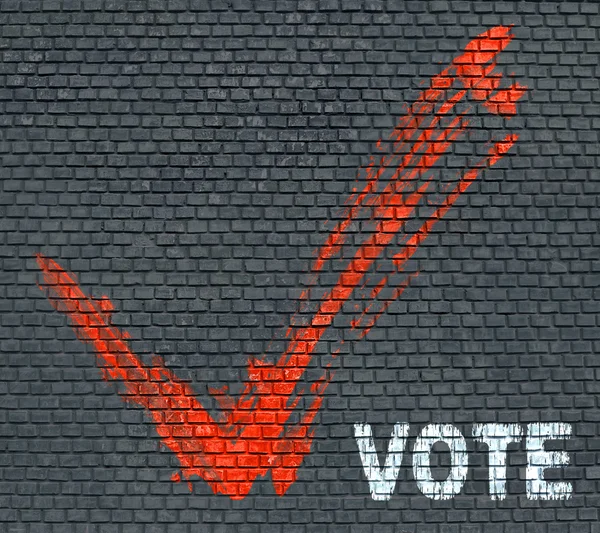 Cocher et mot Votez sur un mur de briques — Photo